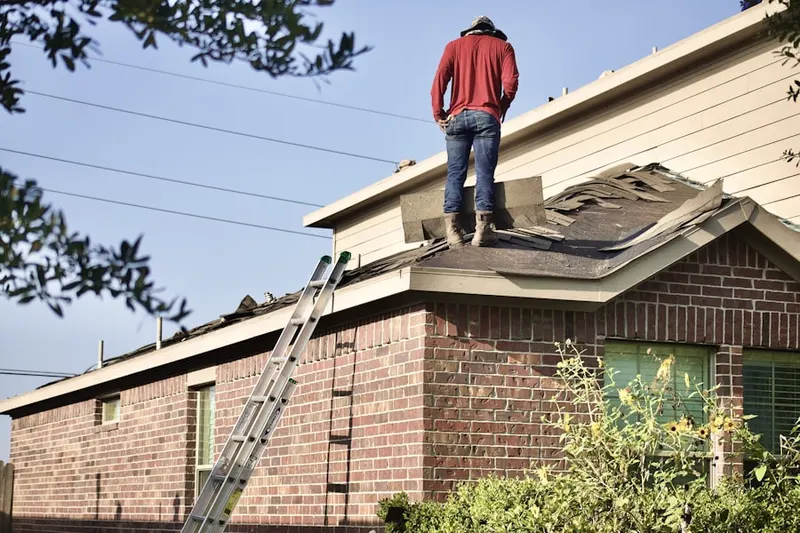 Professional roofer working on a residential roof in Big Woods Marmion